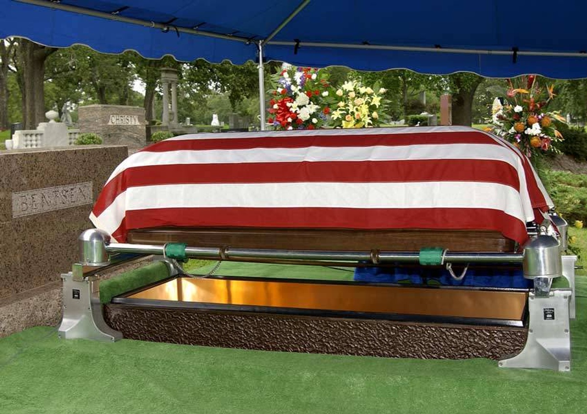 Brown casket covered with Red and White Cloth on Casket lowering Device - Commercial Photography in Houston TX