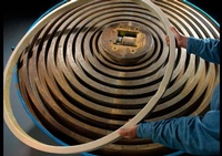 A Worker Arranging Huge Metal Rings Inside a Factory - Photograph by Commercial Photographer in Houston TX, Joe Robbins