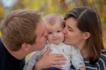 Parents Kissing Baby captured by Family Photographer Minneapolis at Mode T Productions