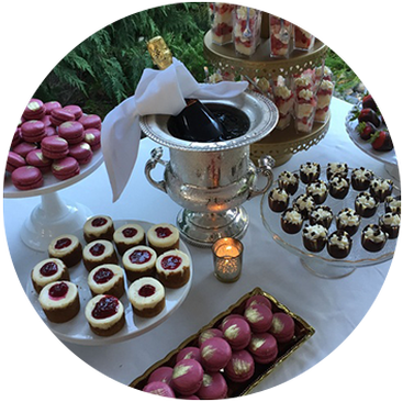 A bottle of wine among a variety of sweets at a Wedding Catering by Christie's Catering in Seattle 