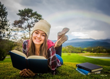 Girl Lying in Lawn with a Book - College Senior Pictures Albuquerque by Kim Jew
