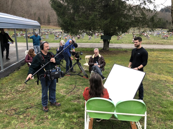 Interview being shot in an open field by Merlin Productions LLC Crew