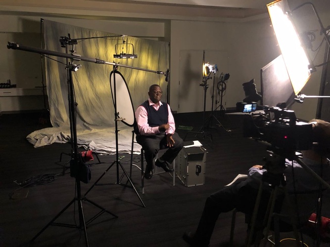 Interview of a man in a dark studio being shot by Merlin Productions LLC 
