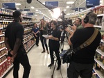Behind the scenes of a interview at the superstore with Merlin Productions LLC Crew