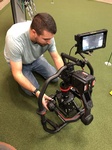 Video Camera on a stable gimbal being operated by Merlin Productions LLC videographer