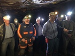 Men with head torch and miners suits standing for a picture
