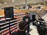 Behind the camera perspective of an interview being shot in a superstore