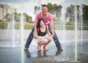 Couple between Fountains captured by Best Edmonton Photographer at Artistic Creations Photography and Video
