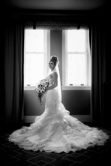 Beautiful Bride Standing Near Window - Wedding Photography Edmonton by Artistic Creations Photography and Video