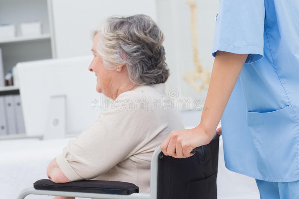 nurse-pushing-senior-patient-wheelchair-clinic-cropped-image-female-49895071.jpg