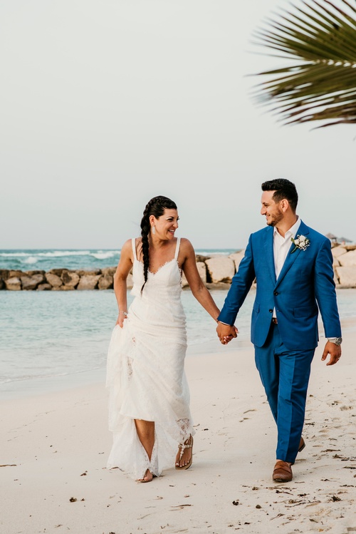 Bride and Groom Walking on the beach - Luxury Wedding Photographer Toronto