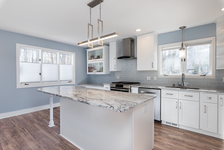 All White Themed Kitchen with a Wooden Flooring - Kitchen Designer Raleigh by Luxury Kitchen Bath Express