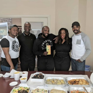Caterers at Scotthill Caribbean Cuisine posing with food to be delivered to clients across Toronto