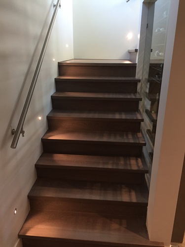 Wooden Staircase with Wall Mounted Handrails by TJL Floor And Garage Door Inc - Flooring Contractor Coquitlam