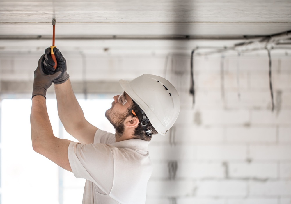 electrician-installer-with-tool-his-hands-working-with-cable-construction-site.jpg