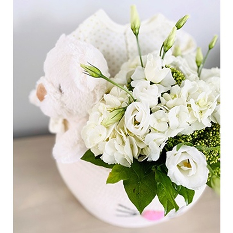 White flowers in baby basket - Brossard Event Florist - YnV Lifestyle Inc.