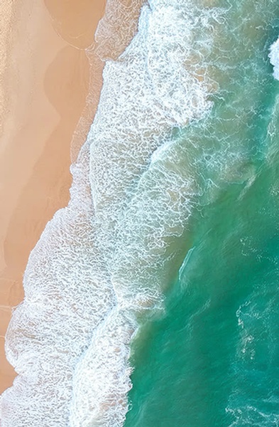 Aerial View Of Sandy Beach And Ocean With Waves
