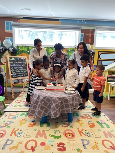 Teachers cutting cake with preschool graduates at HIDE ‘n' SEEK DAYCARE - Day Care Center in Brampton, Ontario