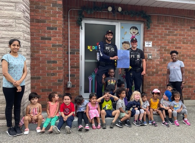 Cops taking picture with children at HIDE ‘n' SEEK DAYCARE - Licensed Childcare Center in Brampton, Ontario