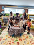 Teachers cutting cake with preschool graduates at HIDE ‘n' SEEK DAYCARE - Day Care Center in Brampton, Ontario