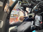 Kid sitting in a cop car at HIDE ‘n' SEEK DAYCARE - Licensed Childcare Center in Brampton, Ontario