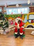 Santa giving Adi gifts for christmas at HIDE ‘n' SEEK DAYCARE - Preschool in Brampton, Ontario