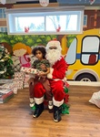 Santa giving Jayton gifts for christmas at HIDE ‘n' SEEK DAYCARE - Childcare and Preschool in Brampton