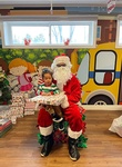 Santa giving Noah gifts for christmas at HIDE ‘n' SEEK DAYCARE - Licensed Childcare Center in Brampton