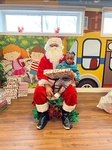 Santa giving Rolly gifts for christmas at HIDE ‘n' SEEK DAYCARE - Licensed Childcare and Preschool in Brampton