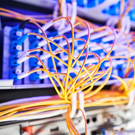 Technicians installing CAT6 network cables in Reno office