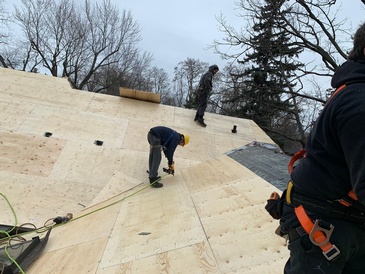 Expert Roofers of Imperial Roofs and Aluminum repairing the wood decking of a home