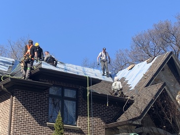 Professional Roofers renovating a home roof with Rubber Roofing Shingles