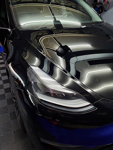 Slide of a Tesla with a glossy polishing and ceramic coating done by Car Passion Detailing
