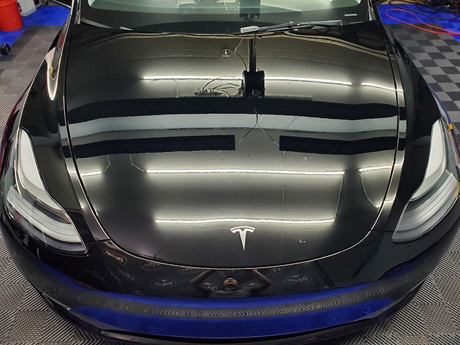 Front view of a Tesla with a glossy polishing and ceramic coating done by Car Passion Detailing