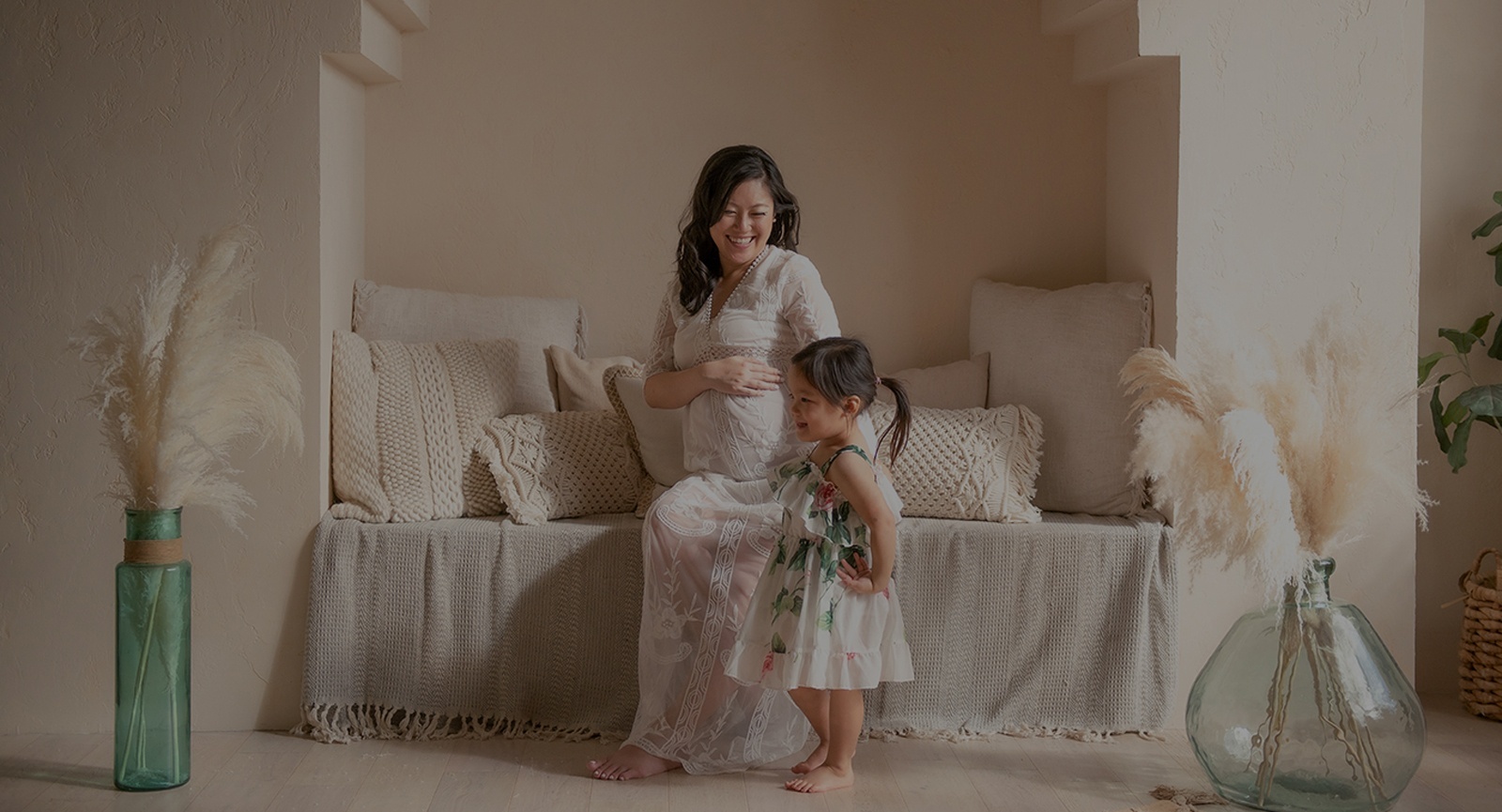 A pregnant mother holding her belly, captured by Toronto Photography Services