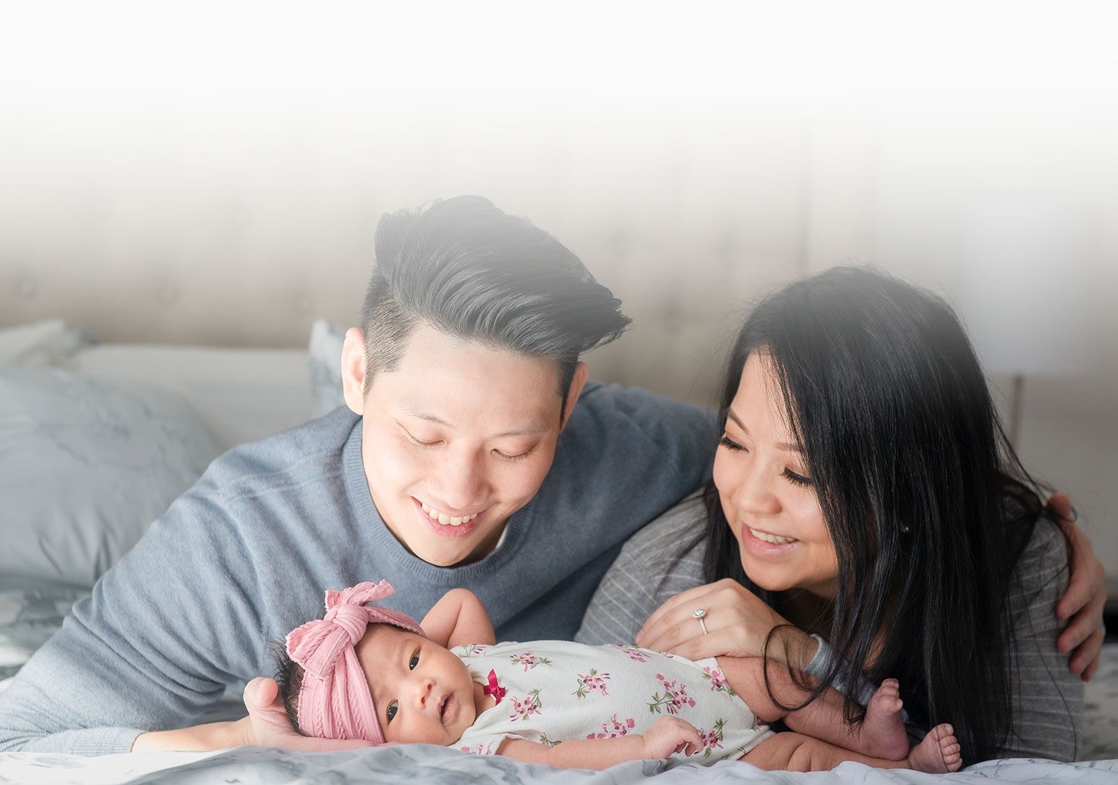 Headshot of a couple with their newborn captured by Flores Photography in Toronto