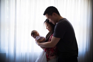 Elegant Portrait of a couple with their newborn captured by Flores Photography in Toronto