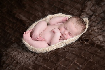 Flores Photography skillfully captures the delicate sleep of a newborn baby in toronto