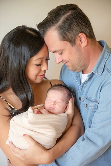 High Quality Headshot photography of a couple with their newborn baby captured by Flores Photography in Toronto