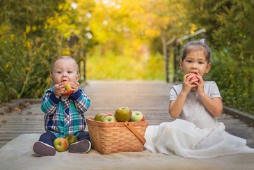 High quality portrait of a young children captured while having good time eating apple in toronto