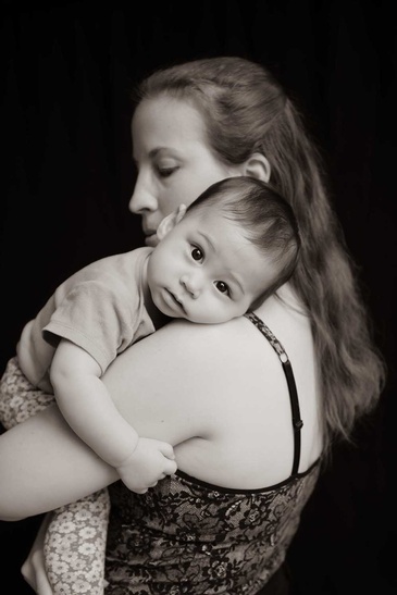 Portrait of mother holding a baby captured by Flores Photography in toronto