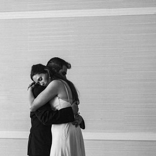 Back and white photo of a couple hugging each other by Darkstrand Visuals