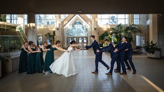 Darkstrand Visuals photographed the bride and groom being pulled apart by the bridesmaids and groomsmen.