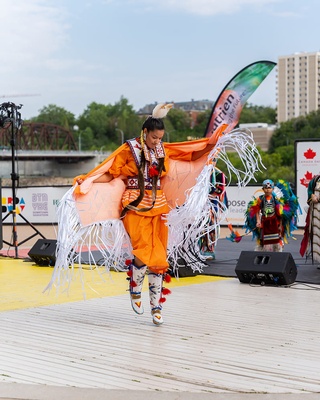 A photograph of a person performing Powwow Style dance by Darkstrand Visuals