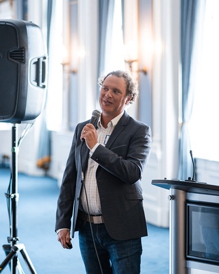 Photograph of a speaker at a professional event by Darkstrand Visuals