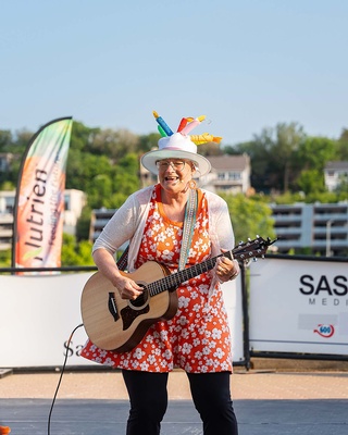 Old lady Singing and playing Guitar at Canada 150 event captured by Darkstrand Visuals