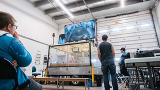 Electronics professionals using a white screen to show how work is done in their factory picture by Darkstrand Visuals