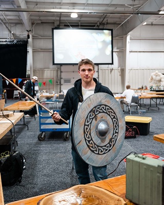 Darkstrand Visuals photographed a man posing with a shield and a sword at an event