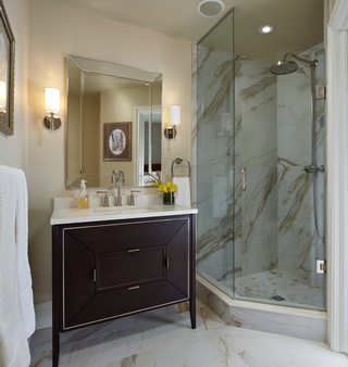 Concept Build Group's bathroom renovation includes a glass shower partition and a luxurious Jacuzzi.