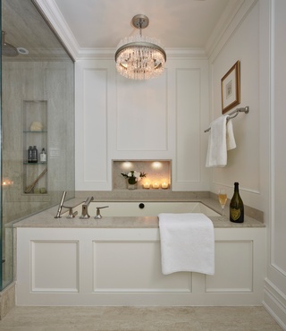 Bathroom Remodelling with a luxurious bathtub and a stunning chandelier by Concept Build Group